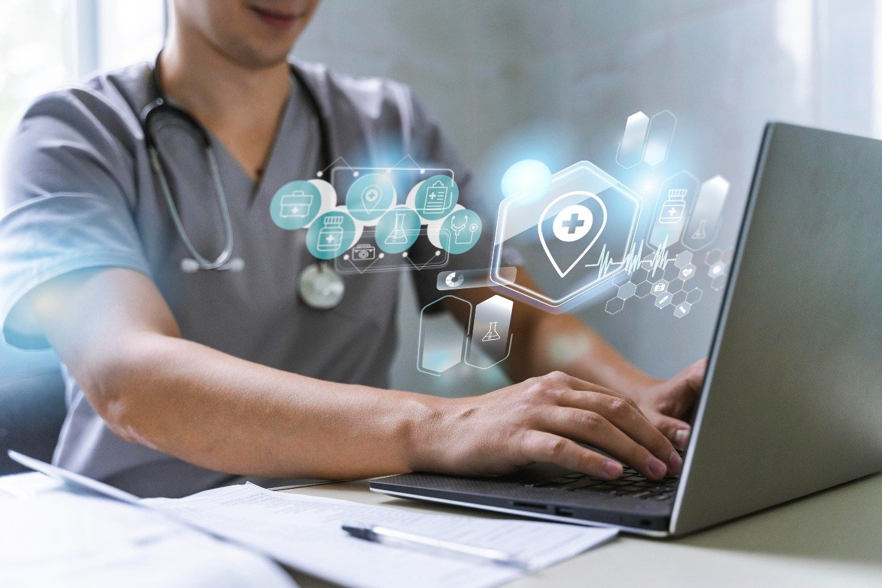 Doctor typing on a laptop