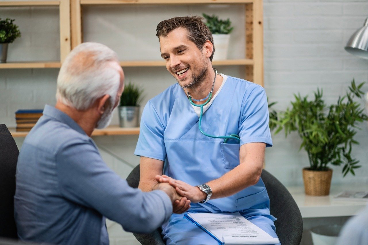 Doctor shaking hands with an elderly patient